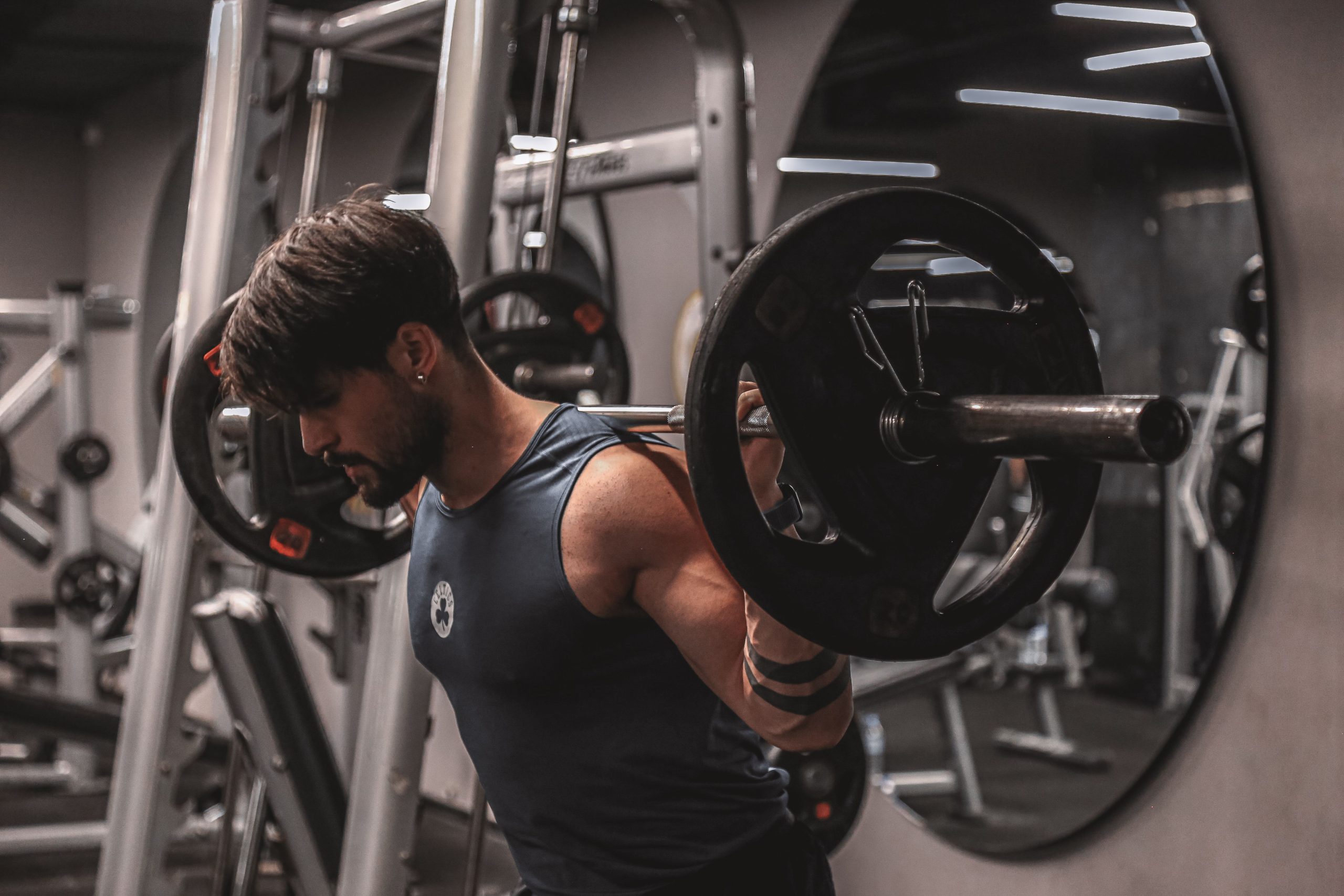 Man exercising with bar at gym